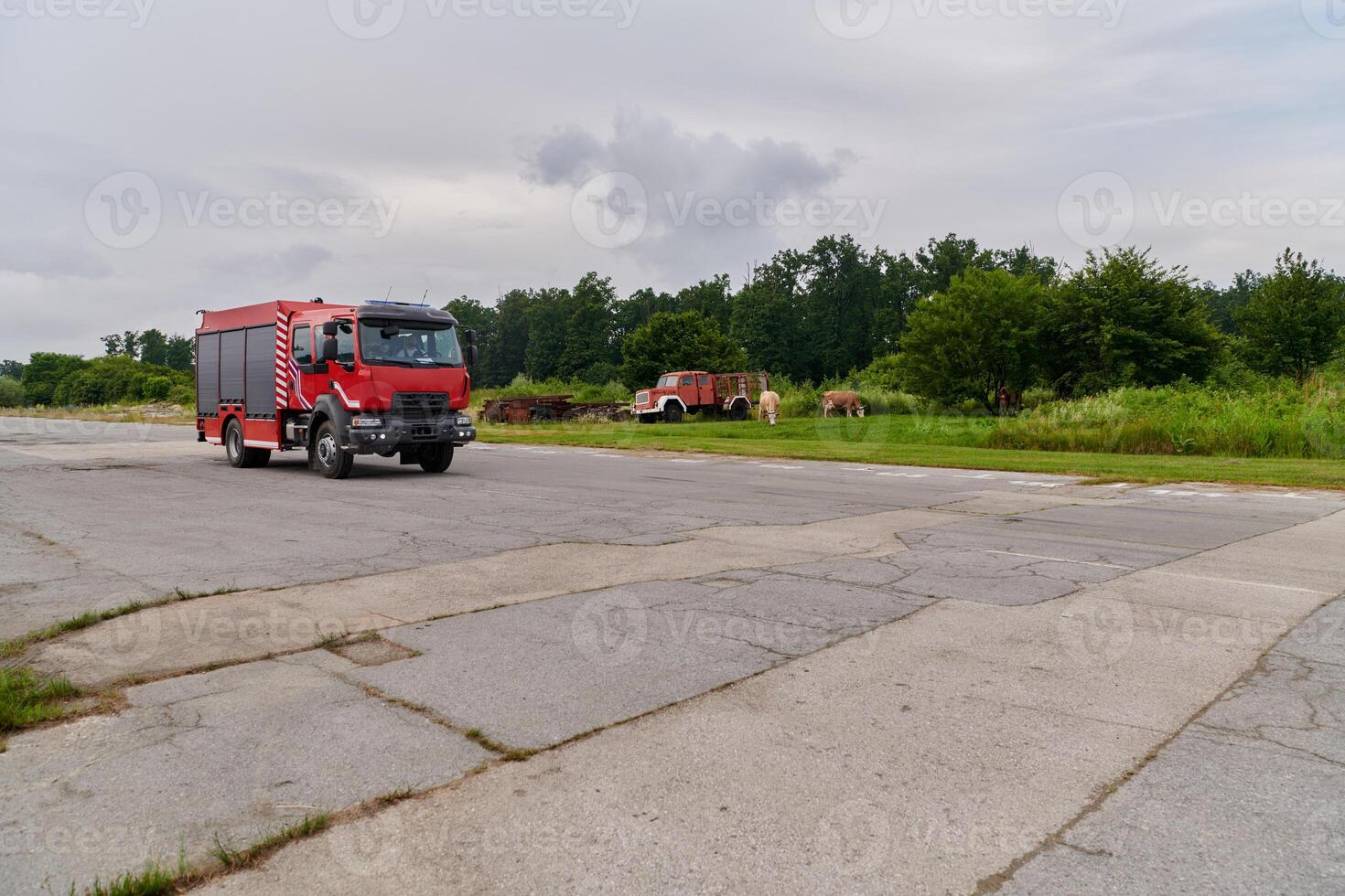 In this captivating scene, a state-of-the-art firetruck, equipped with advanced rescue technology, stands ready with its skilled firefighting team, prepared to intervene and respond rapidly to photo