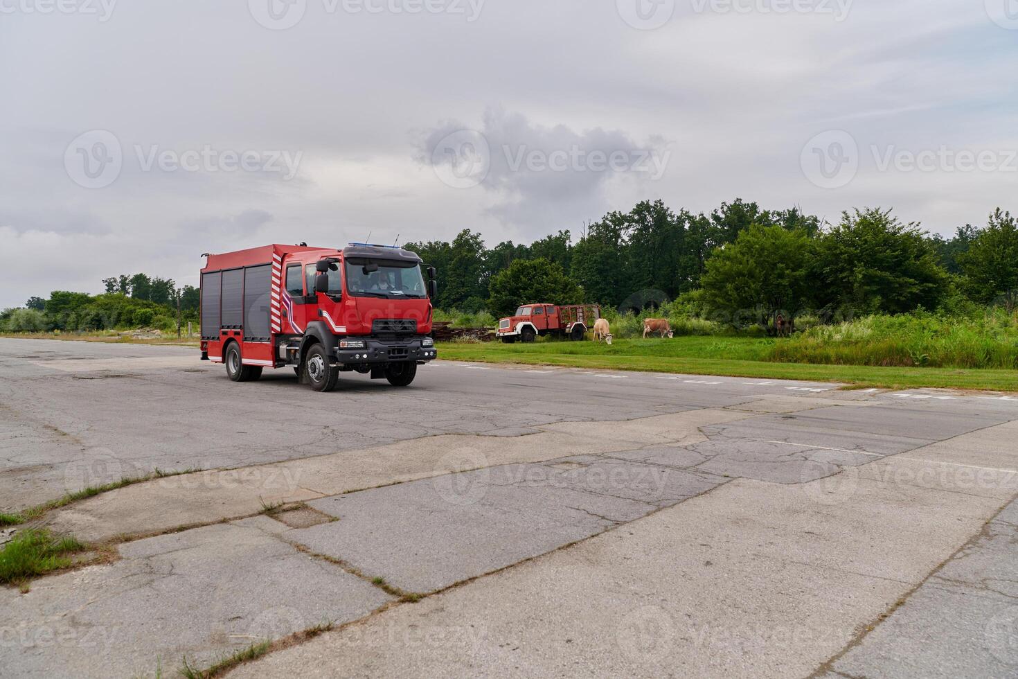 In this captivating scene, a state-of-the-art firetruck, equipped with advanced rescue technology, stands ready with its skilled firefighting team, prepared to intervene and respond rapidly to photo