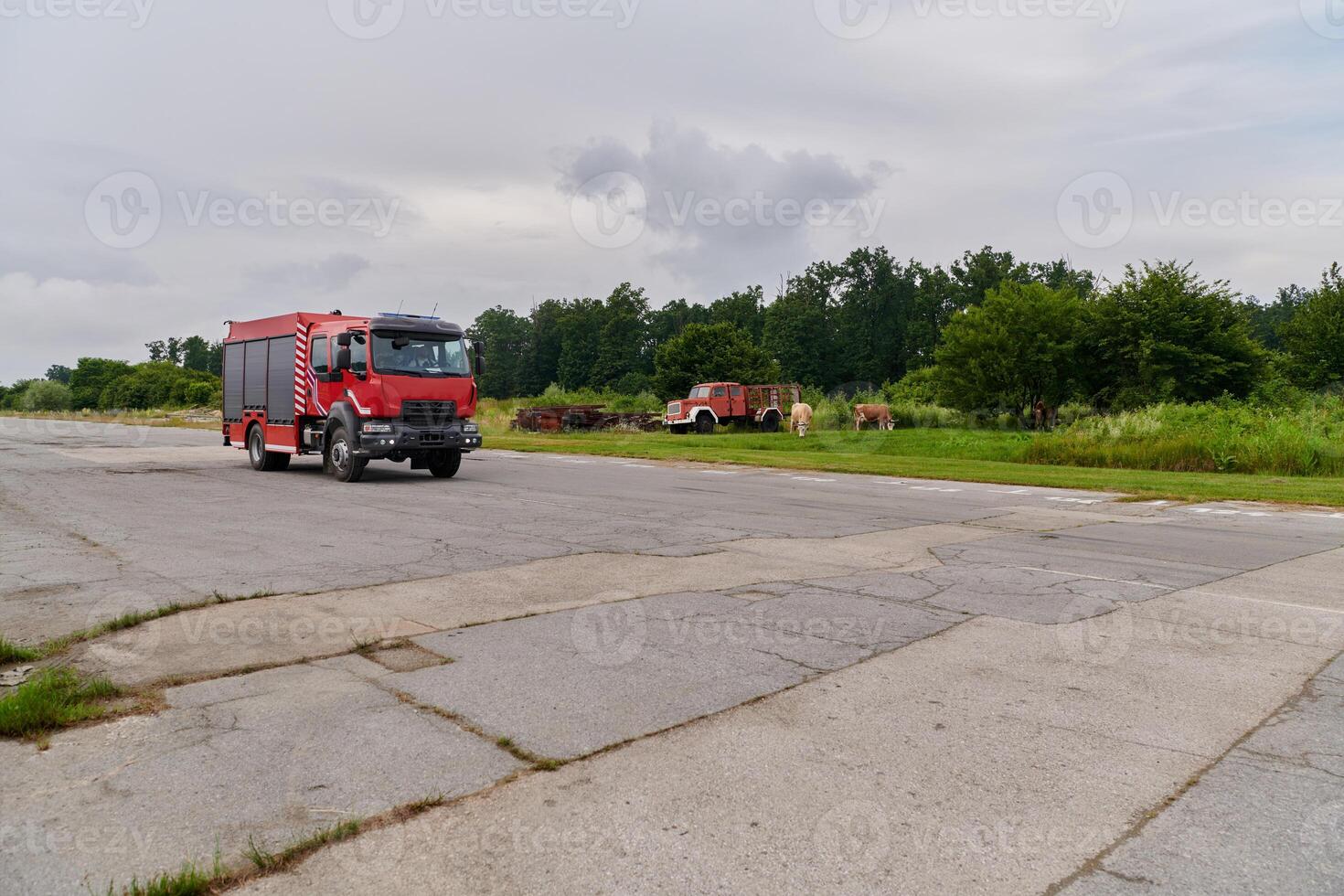In this captivating scene, a state-of-the-art firetruck, equipped with advanced rescue technology, stands ready with its skilled firefighting team, prepared to intervene and respond rapidly to photo