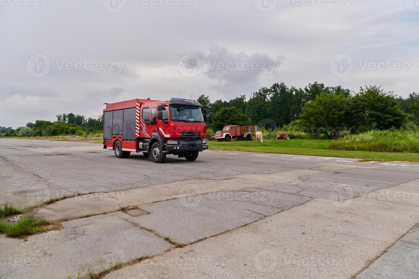 In this captivating scene, a state-of-the-art firetruck, equipped with advanced rescue technology, stands ready with its skilled firefighting team, prepared to intervene and respond rapidly to photo