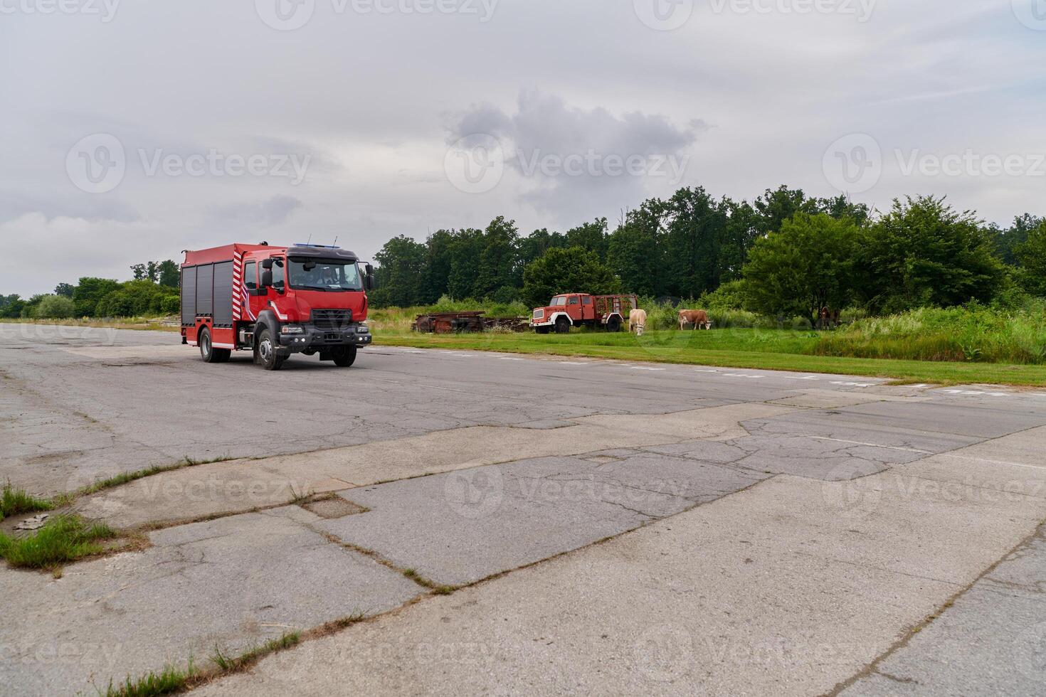 In this captivating scene, a state-of-the-art firetruck, equipped with advanced rescue technology, stands ready with its skilled firefighting team, prepared to intervene and respond rapidly to photo