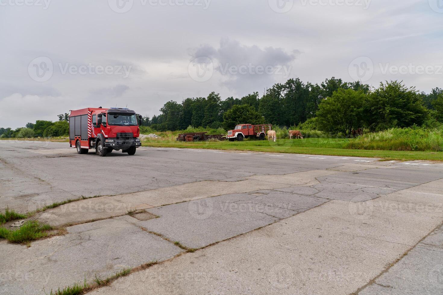 In this captivating scene, a state-of-the-art firetruck, equipped with advanced rescue technology, stands ready with its skilled firefighting team, prepared to intervene and respond rapidly to photo
