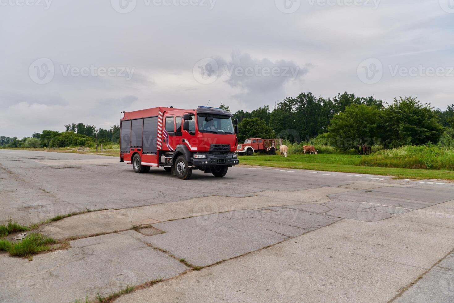 In this captivating scene, a state-of-the-art firetruck, equipped with advanced rescue technology, stands ready with its skilled firefighting team, prepared to intervene and respond rapidly to photo