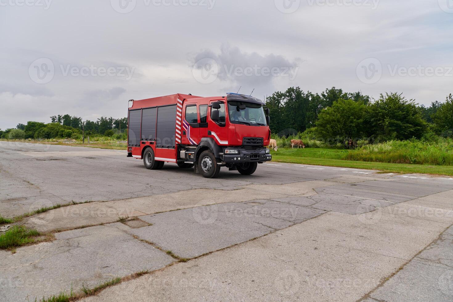 In this captivating scene, a state-of-the-art firetruck, equipped with advanced rescue technology, stands ready with its skilled firefighting team, prepared to intervene and respond rapidly to photo