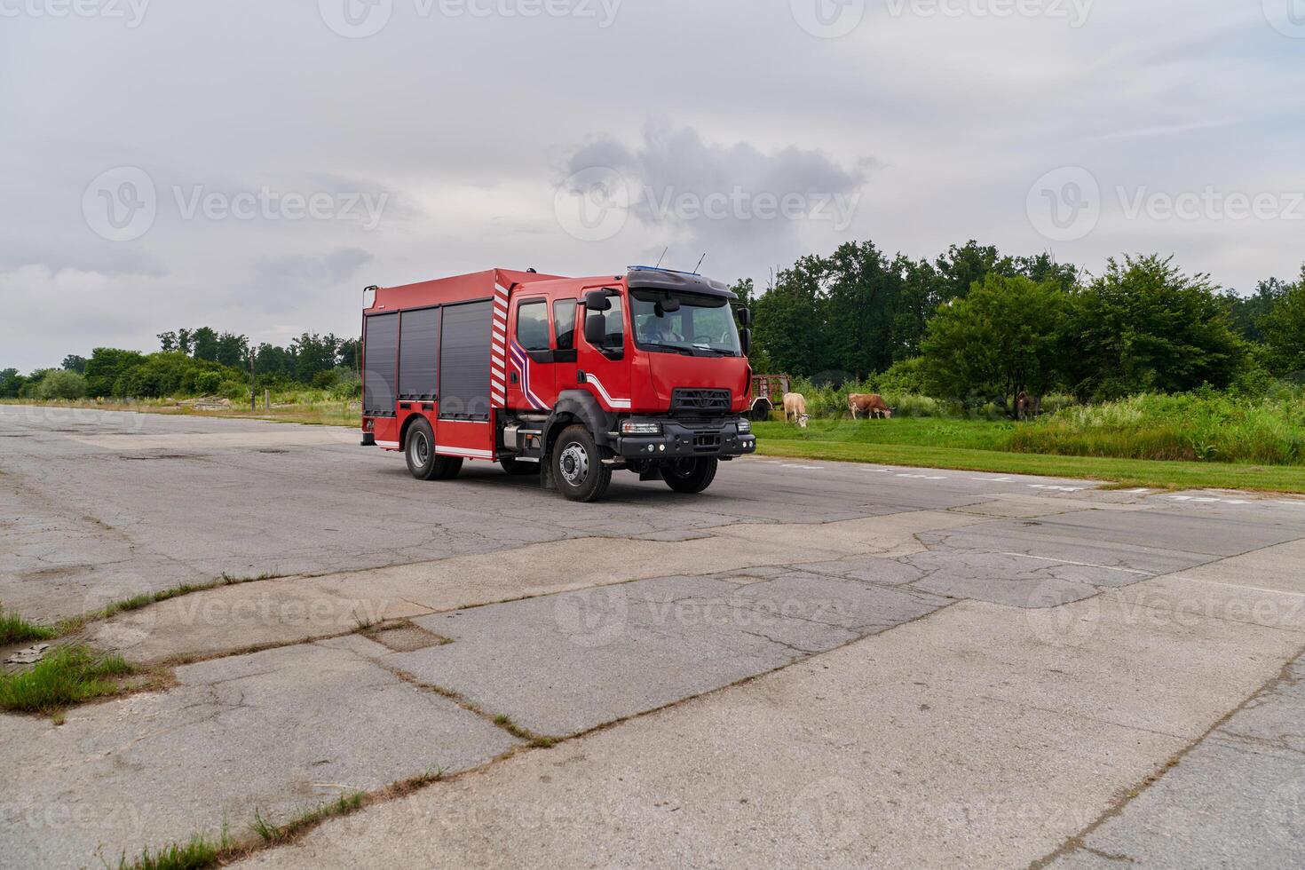 In this captivating scene, a state-of-the-art firetruck, equipped with advanced rescue technology, stands ready with its skilled firefighting team, prepared to intervene and respond rapidly to photo
