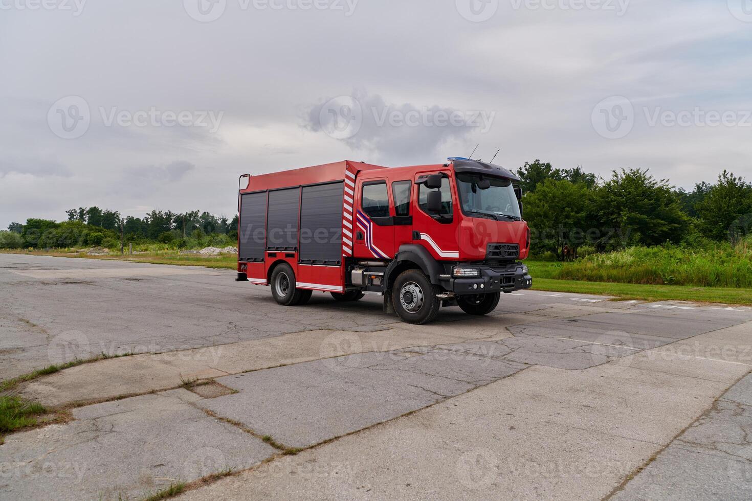 In this captivating scene, a state-of-the-art firetruck, equipped with advanced rescue technology, stands ready with its skilled firefighting team, prepared to intervene and respond rapidly to photo