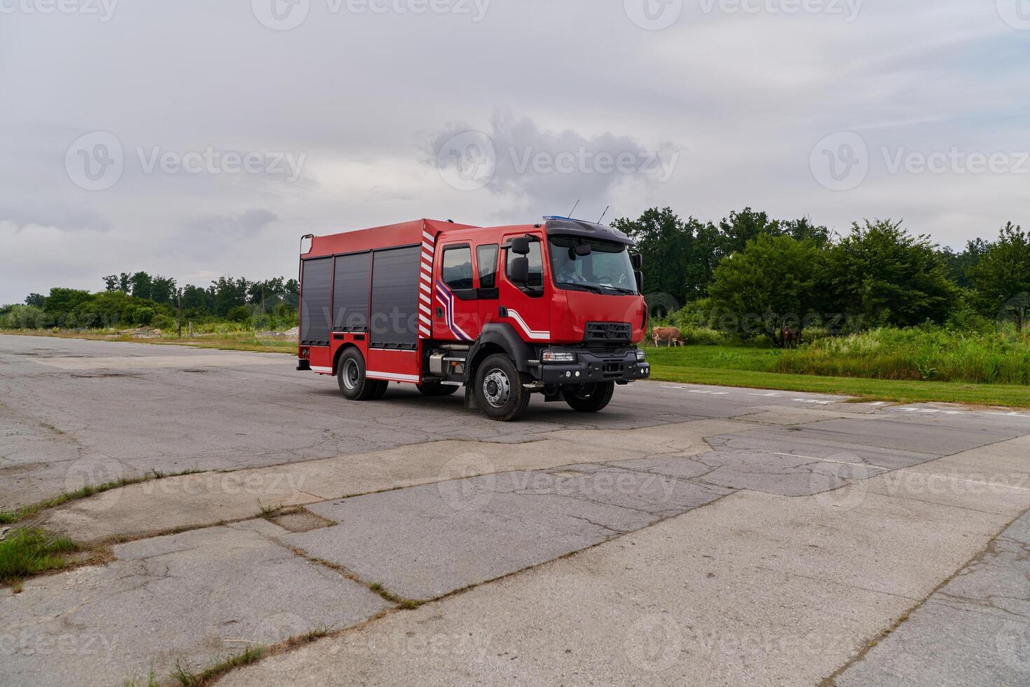 In this captivating scene, a state-of-the-art firetruck, equipped with advanced rescue technology, stands ready with its skilled firefighting team, prepared to intervene and respond rapidly to photo