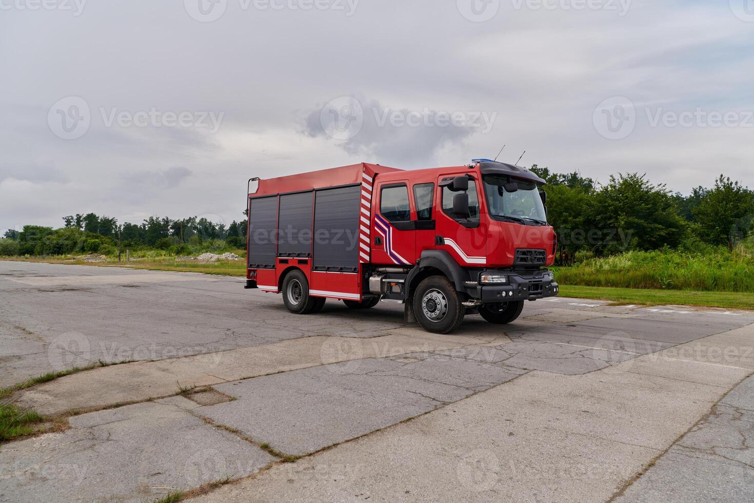 In this captivating scene, a state-of-the-art firetruck, equipped with advanced rescue technology, stands ready with its skilled firefighting team, prepared to intervene and respond rapidly to photo
