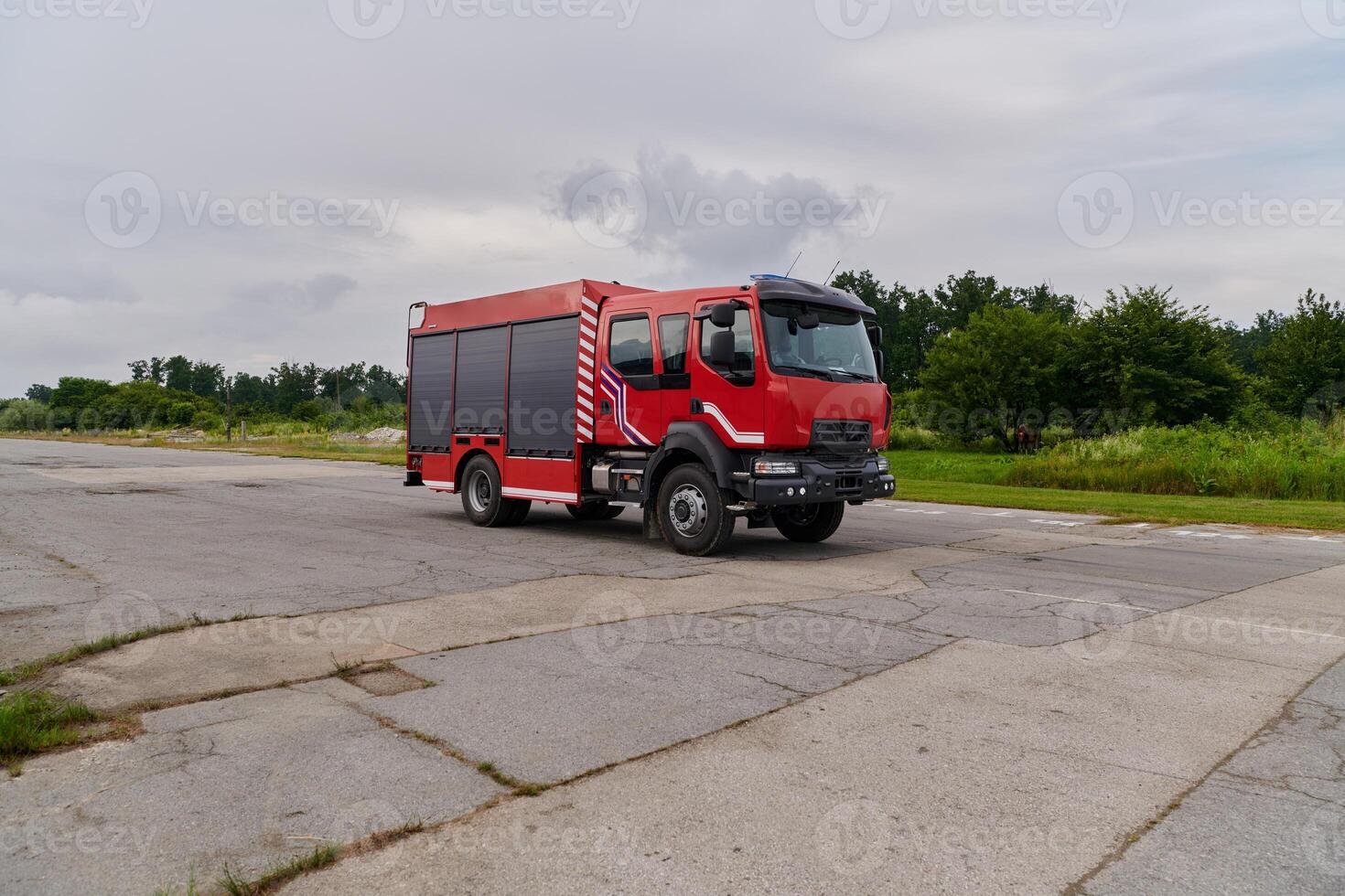 In this captivating scene, a state-of-the-art firetruck, equipped with advanced rescue technology, stands ready with its skilled firefighting team, prepared to intervene and respond rapidly to photo