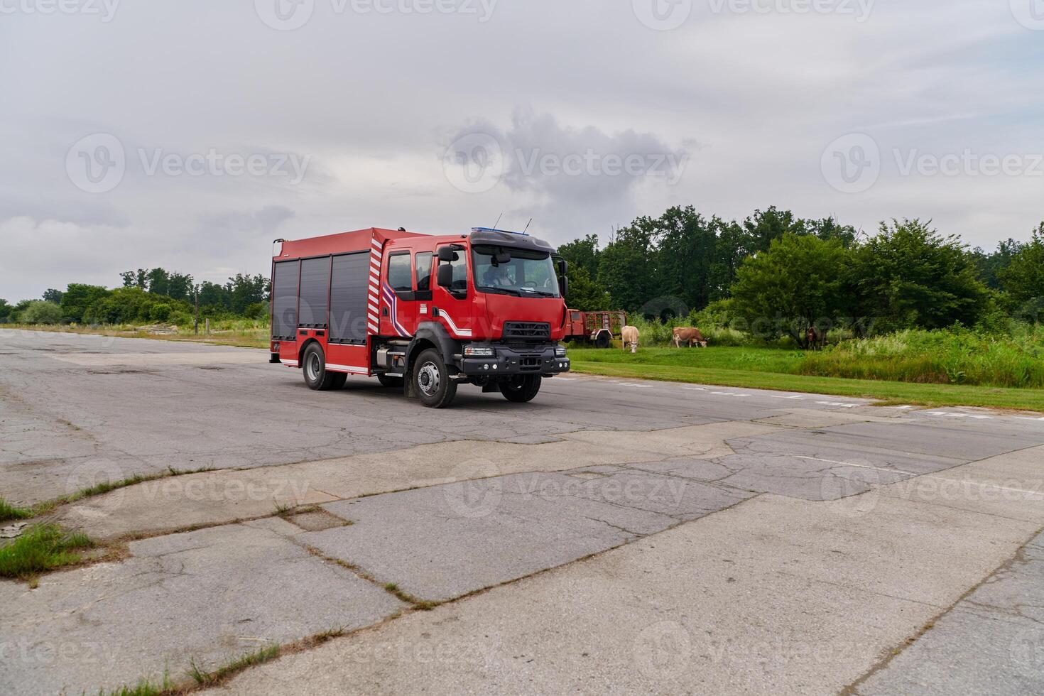 In this captivating scene, a state-of-the-art firetruck, equipped with advanced rescue technology, stands ready with its skilled firefighting team, prepared to intervene and respond rapidly to photo
