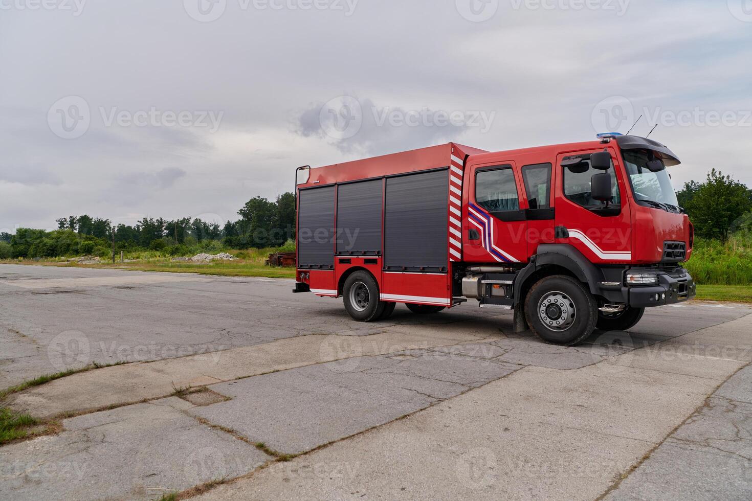 In this captivating scene, a state-of-the-art firetruck, equipped with advanced rescue technology, stands ready with its skilled firefighting team, prepared to intervene and respond rapidly to photo