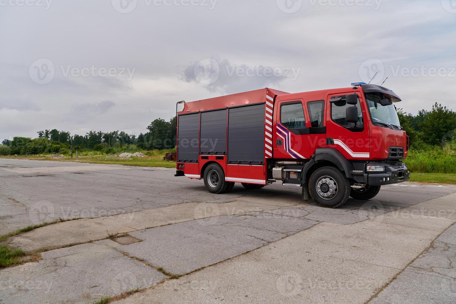 In this captivating scene, a state-of-the-art firetruck, equipped with advanced rescue technology, stands ready with its skilled firefighting team, prepared to intervene and respond rapidly to photo