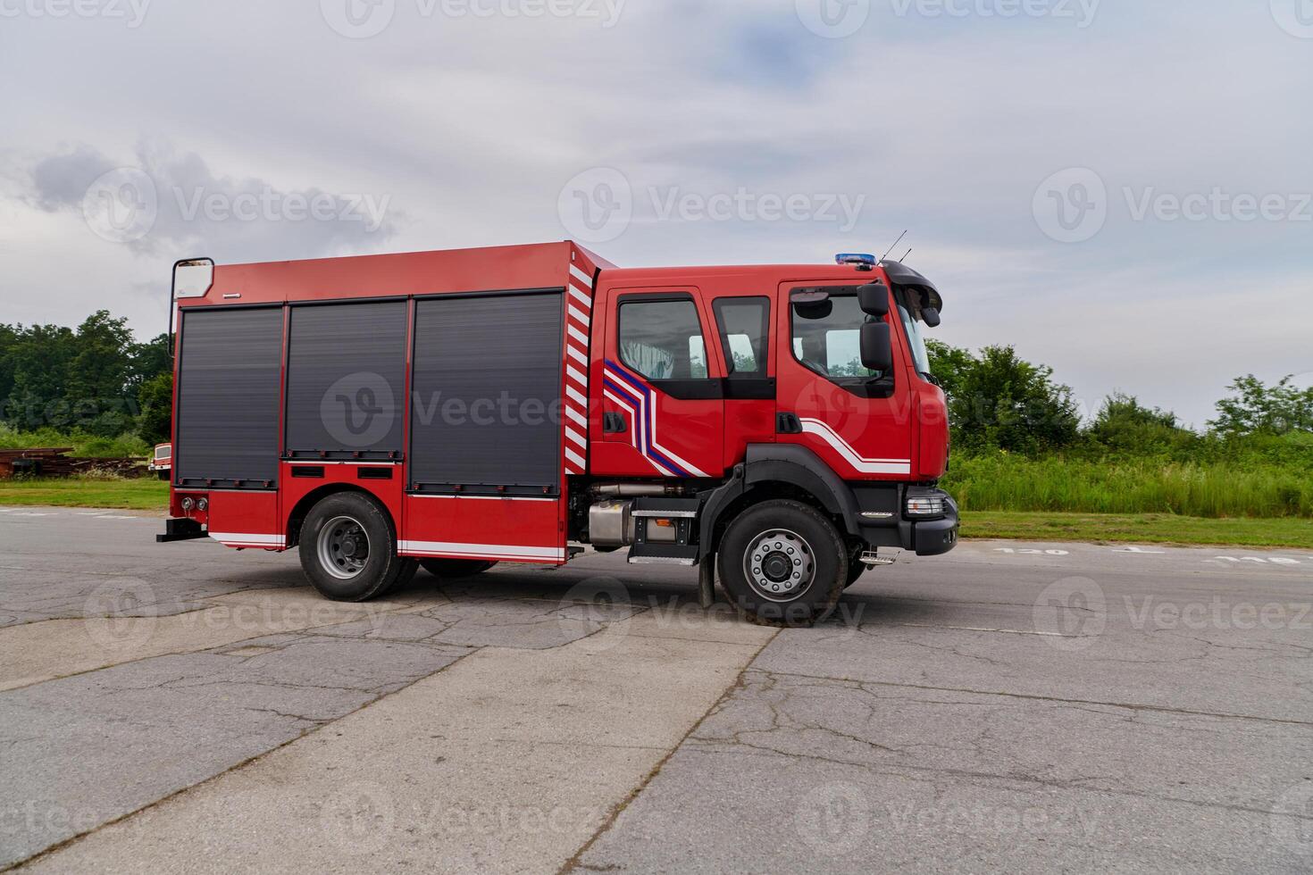 In this captivating scene, a state-of-the-art firetruck, equipped with advanced rescue technology, stands ready with its skilled firefighting team, prepared to intervene and respond rapidly to photo