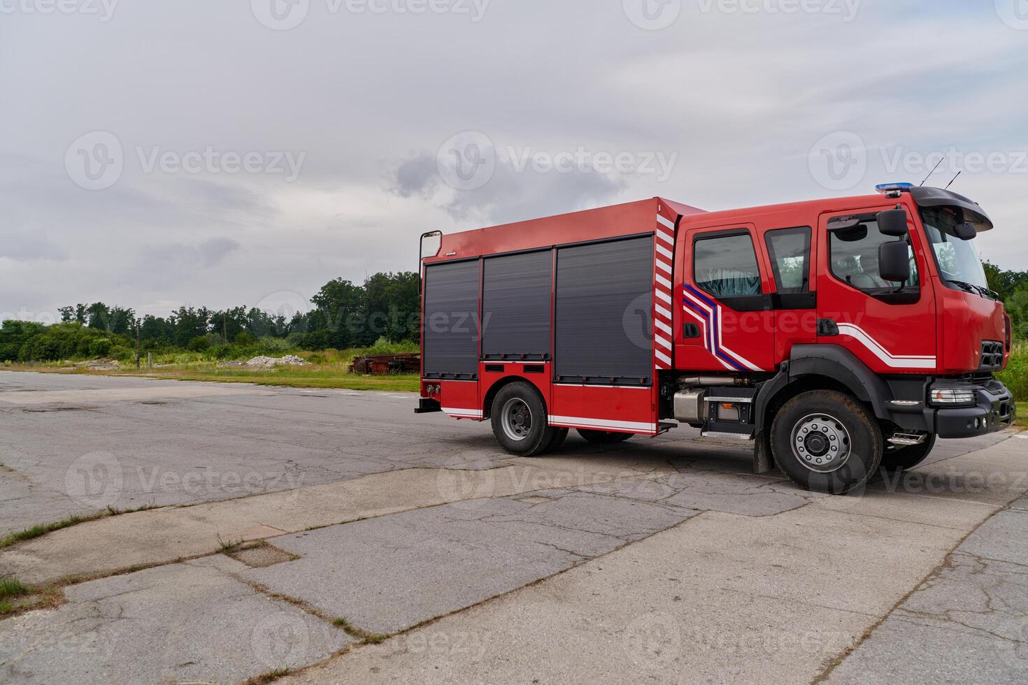 In this captivating scene, a state-of-the-art firetruck, equipped with advanced rescue technology, stands ready with its skilled firefighting team, prepared to intervene and respond rapidly to photo