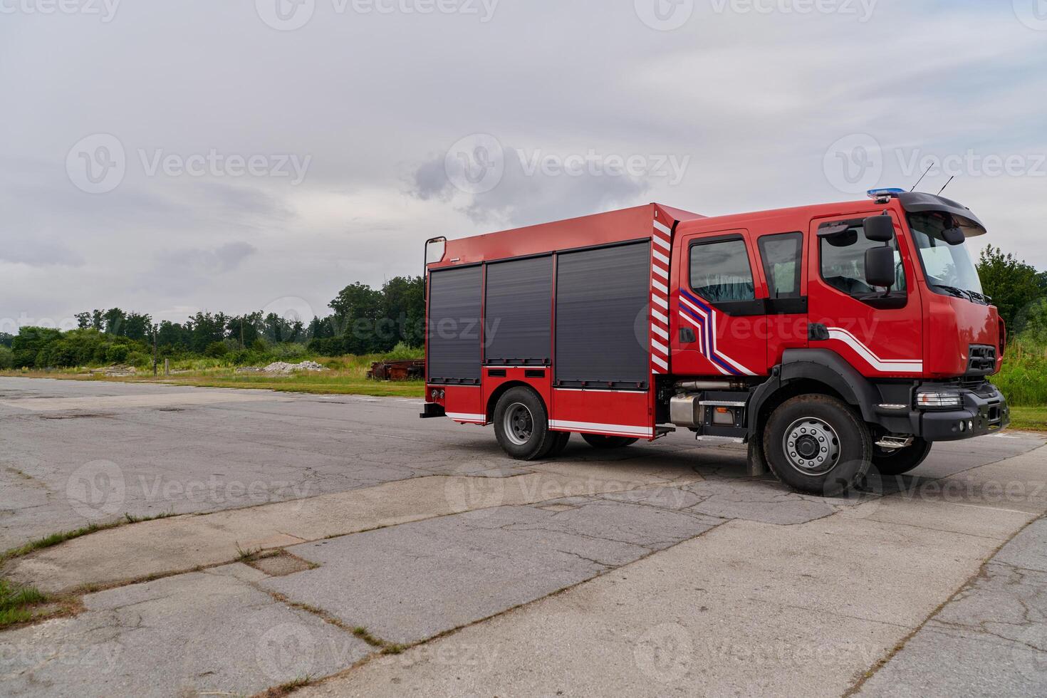 In this captivating scene, a state-of-the-art firetruck, equipped with advanced rescue technology, stands ready with its skilled firefighting team, prepared to intervene and respond rapidly to photo
