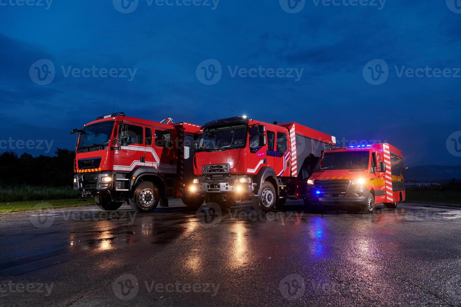 A pair of highly modern and quality fire trucks illuminate the night with their rotating lights, symbolizing the cutting-edge technology and preparedness of the firefighting fleet, ready to respond to photo