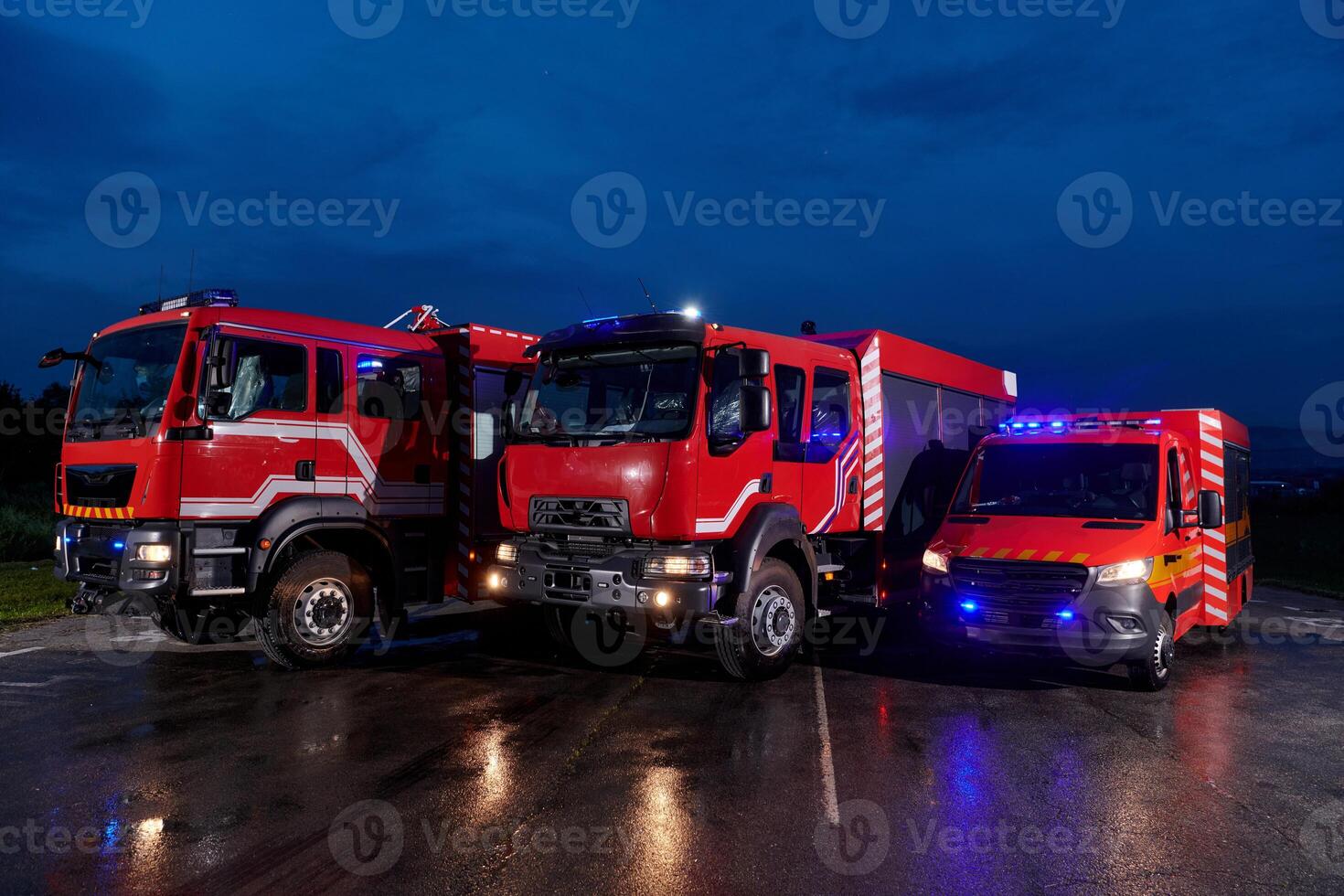 A pair of highly modern and quality fire trucks illuminate the night with their rotating lights, symbolizing the cutting-edge technology and preparedness of the firefighting fleet, ready to respond to photo