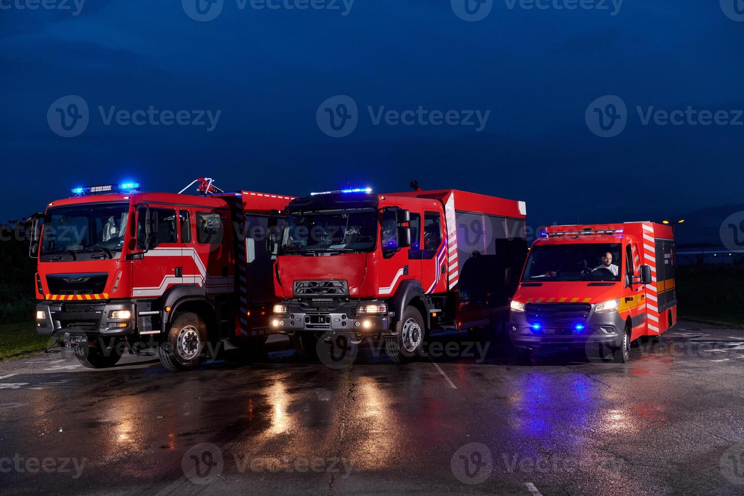 A pair of highly modern and quality fire trucks illuminate the night with their rotating lights, symbolizing the cutting-edge technology and preparedness of the firefighting fleet, ready to respond to photo