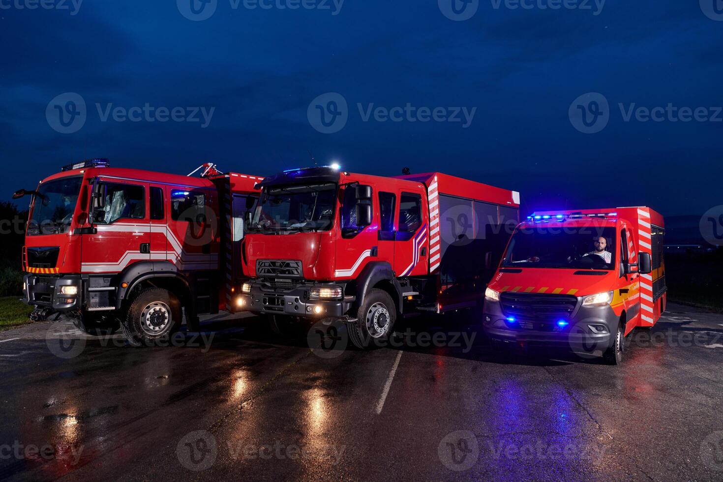 A pair of highly modern and quality fire trucks illuminate the night with their rotating lights, symbolizing the cutting-edge technology and preparedness of the firefighting fleet, ready to respond to photo