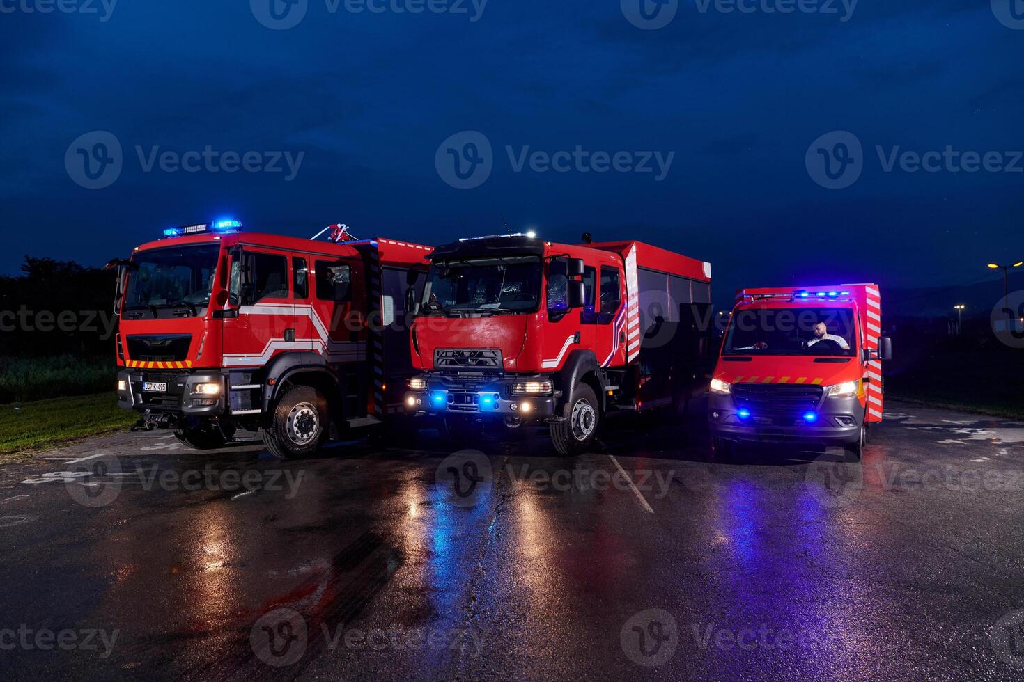 A pair of highly modern and quality fire trucks illuminate the night with their rotating lights, symbolizing the cutting-edge technology and preparedness of the firefighting fleet, ready to respond to photo
