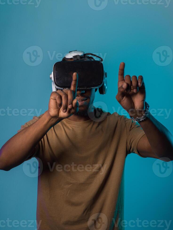 Immersed in a digital realm, an African American man navigates the virtual landscape with a VR goggles, using tactile gestures to interact with virtual objects, showcasing a harmonious blend of photo