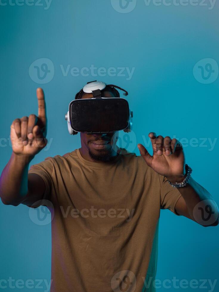 Immersed in a digital realm, an African American man navigates the virtual landscape with a VR goggles, using tactile gestures to interact with virtual objects, showcasing a harmonious blend of photo