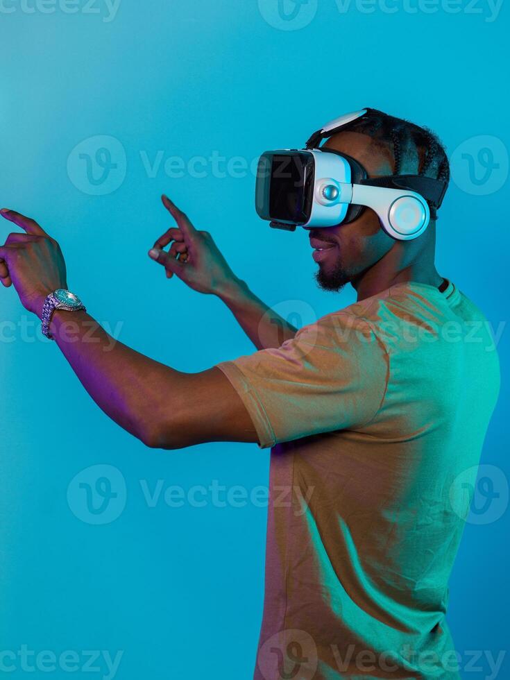 Immersed in a digital realm, an African American man navigates the virtual landscape with a VR goggles, using tactile gestures to interact with virtual objects, showcasing a harmonious blend of photo