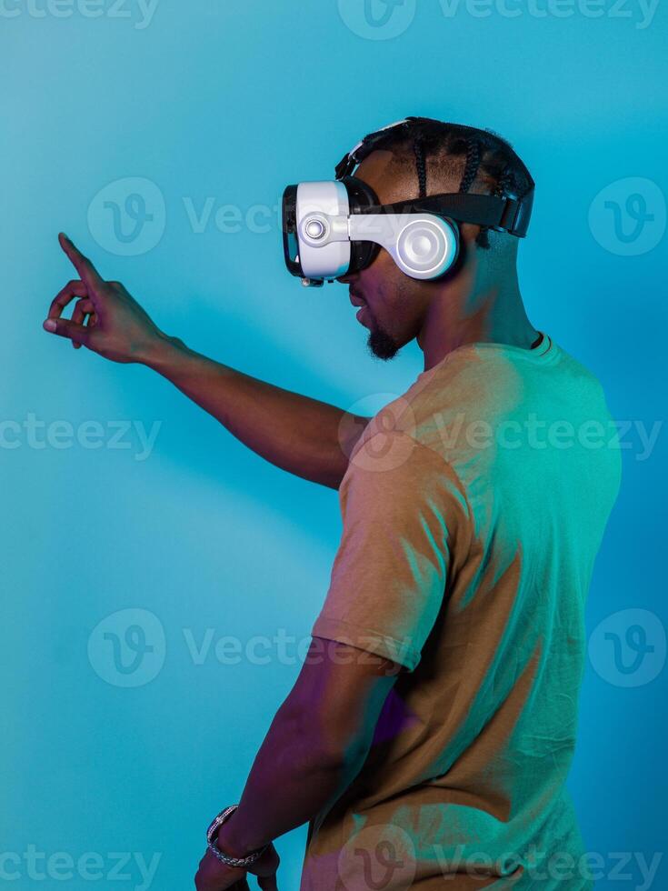 Immersed in a digital realm, an African American man navigates the virtual landscape with a VR goggles, using tactile gestures to interact with virtual objects, showcasing a harmonious blend of photo