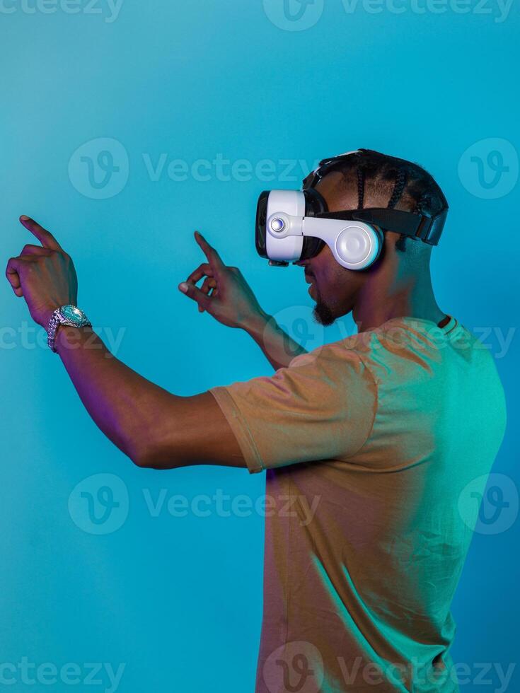 Immersed in a digital realm, an African American man navigates the virtual landscape with a VR goggles, using tactile gestures to interact with virtual objects, showcasing a harmonious blend of photo