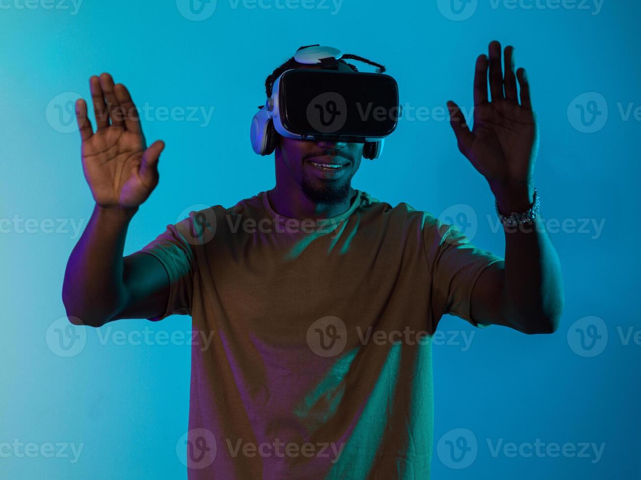 Immersed in a digital realm, an African American man navigates the virtual landscape with a VR goggles, using tactile gestures to interact with virtual objects, showcasing a harmonious blend of photo
