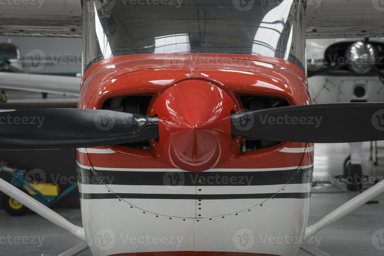 Front part of a light aircraft with a propeller. Close-up, screws, texture, red surface photo