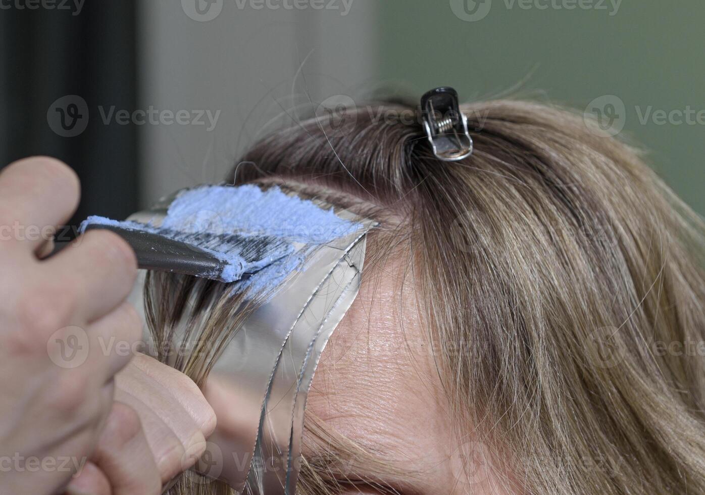 Fixing the hair on the head during the dyeing process. use of foil. selected focus. photo