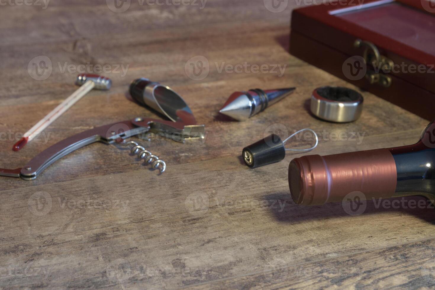 Set of accessories for bottled wine. Additional stoppers, means for opening, a corkscrew, a thermometer. On the texture table. Close-up. Place for text photo