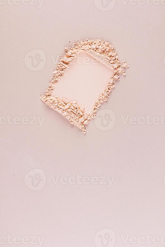 A sample of loose powder for makeup. A universal shade for all skin types. The top vertical view with a copy space. Layout of natural cosmetics. photo