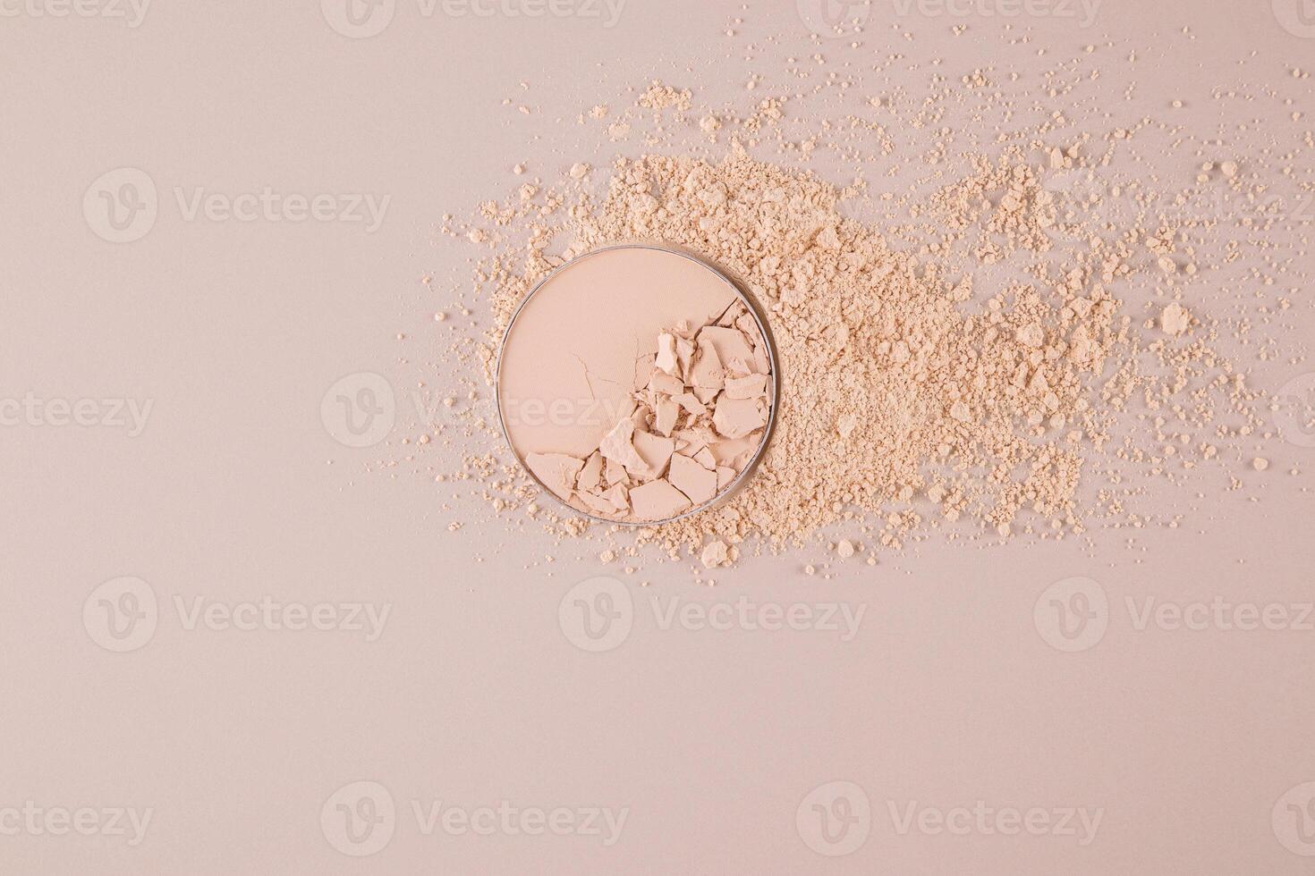 A block of compact powder in a natural tone with the texture of broken pieces stands on a swatch of powder. loose powder. A copy space. top view. photo