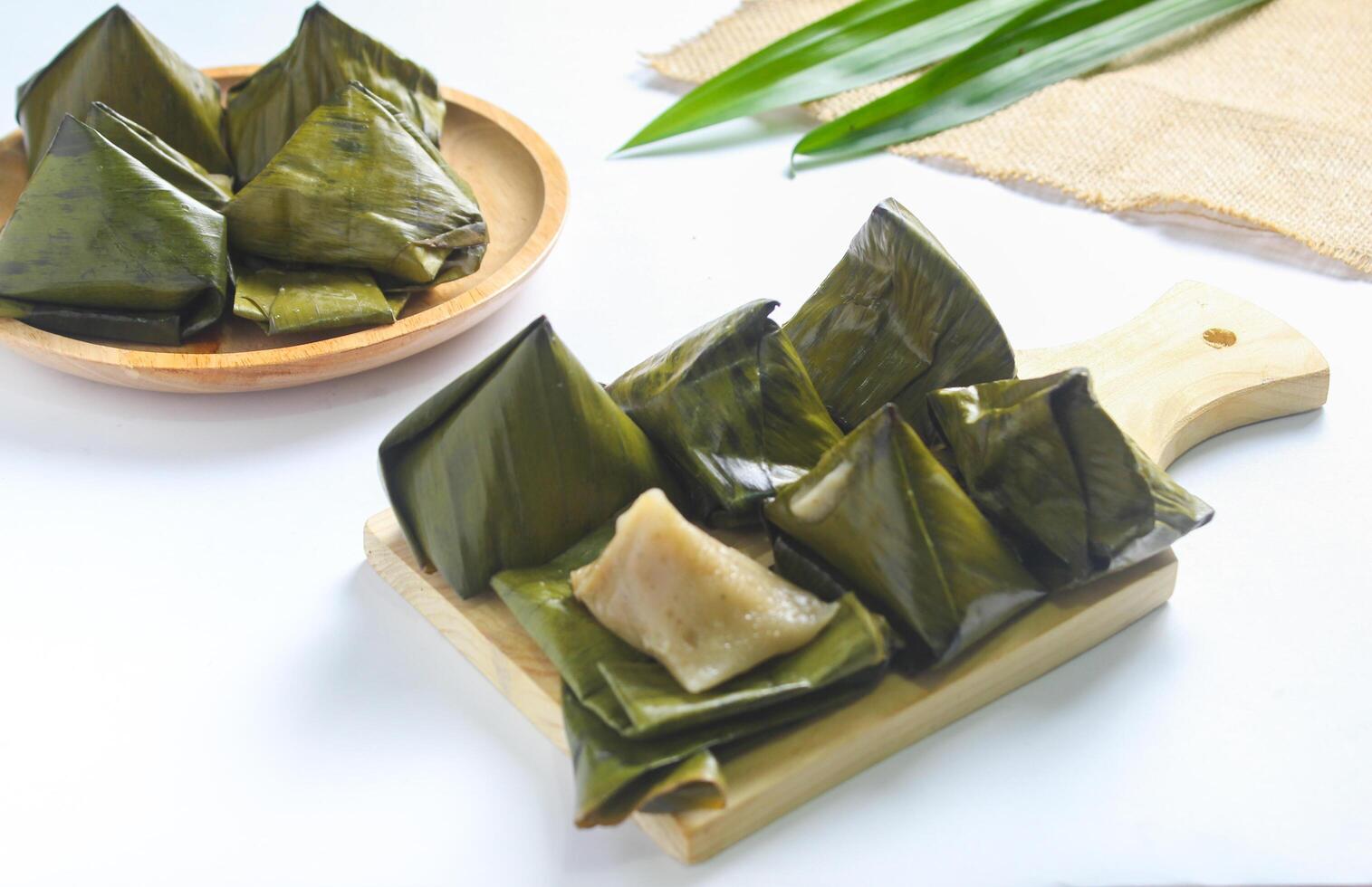 Bugis cake, traditional Indonesian food in the form of cake made from sticky rice flour filled with sweet grated coconut and wrapped in banana leaves. photo