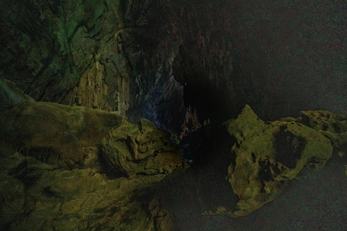 The beautiful views of the stalactite and stalagmite-filled cave in Lam Khlong Ngu National Park, Thailand. At the cave's exit is a small waterfall also. photo