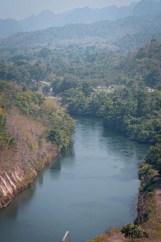An aerial view of the dam-caused canal in Thailand's national park, with a mountain the background. Bird eye view. photo