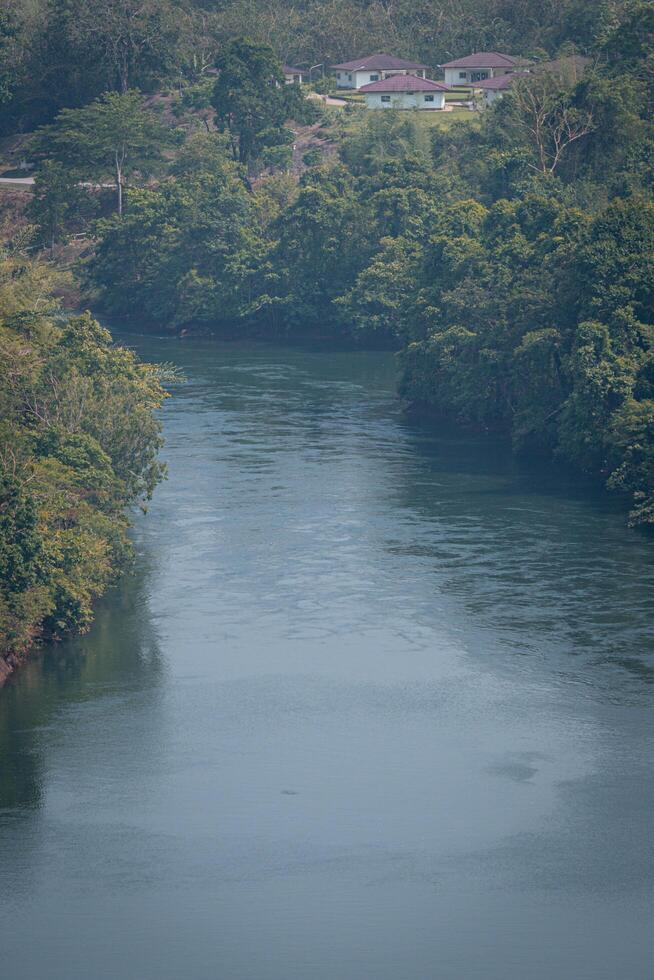 An aerial view of the dam-caused canal in Thailand's national park, with a mountain the background. Bird eye view. photo