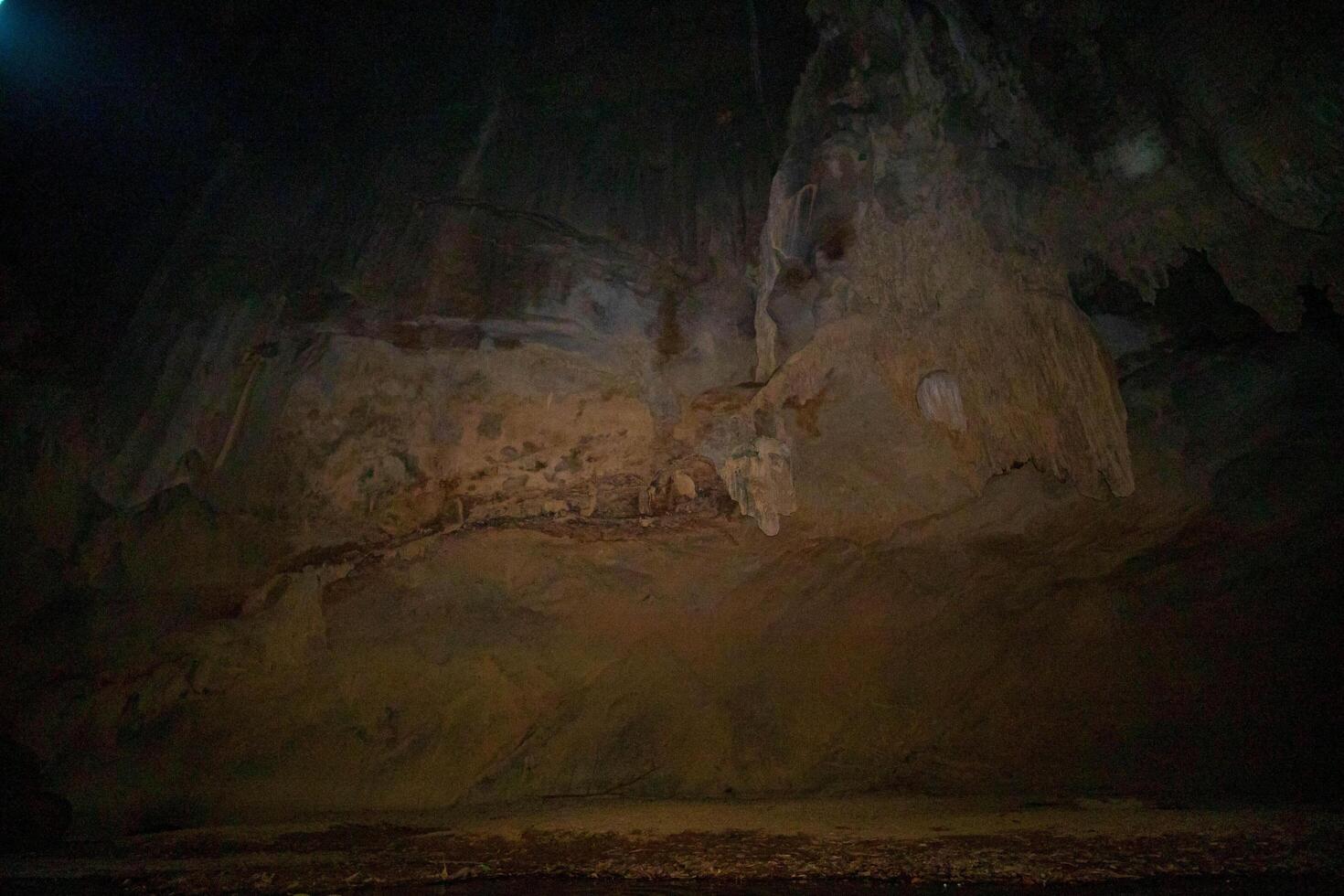 The beautiful views of the stalactite and stalagmite-filled cave in Lam Khlong Ngu National Park, Thailand. At the cave's exit is a small waterfall also. photo
