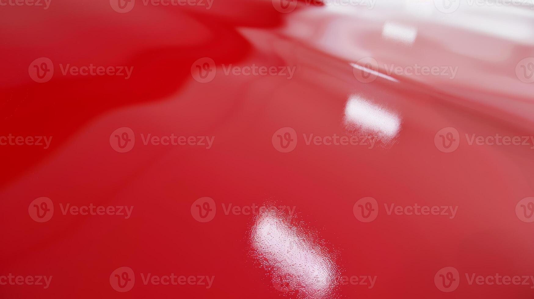 Shiny Red Plastic Surface with Light Reflections, Ideal for Backgrounds and Textures photo