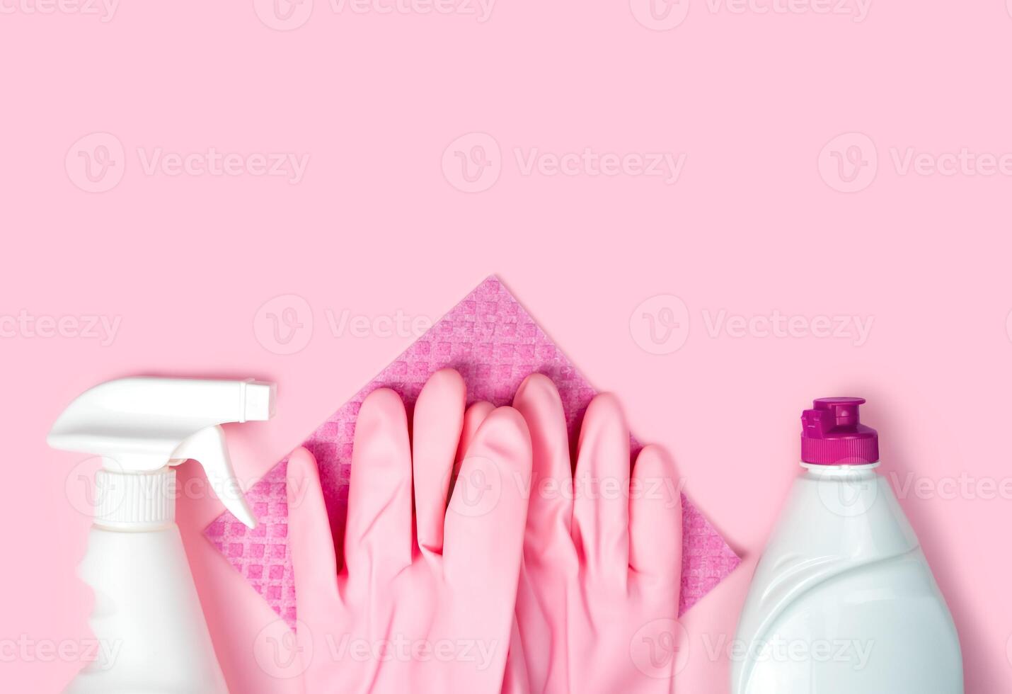 Detergent, cleaner, rubber gloves and cleaning sponge on a pink background. Flatlay. Close-up. Top view. Copy space. photo