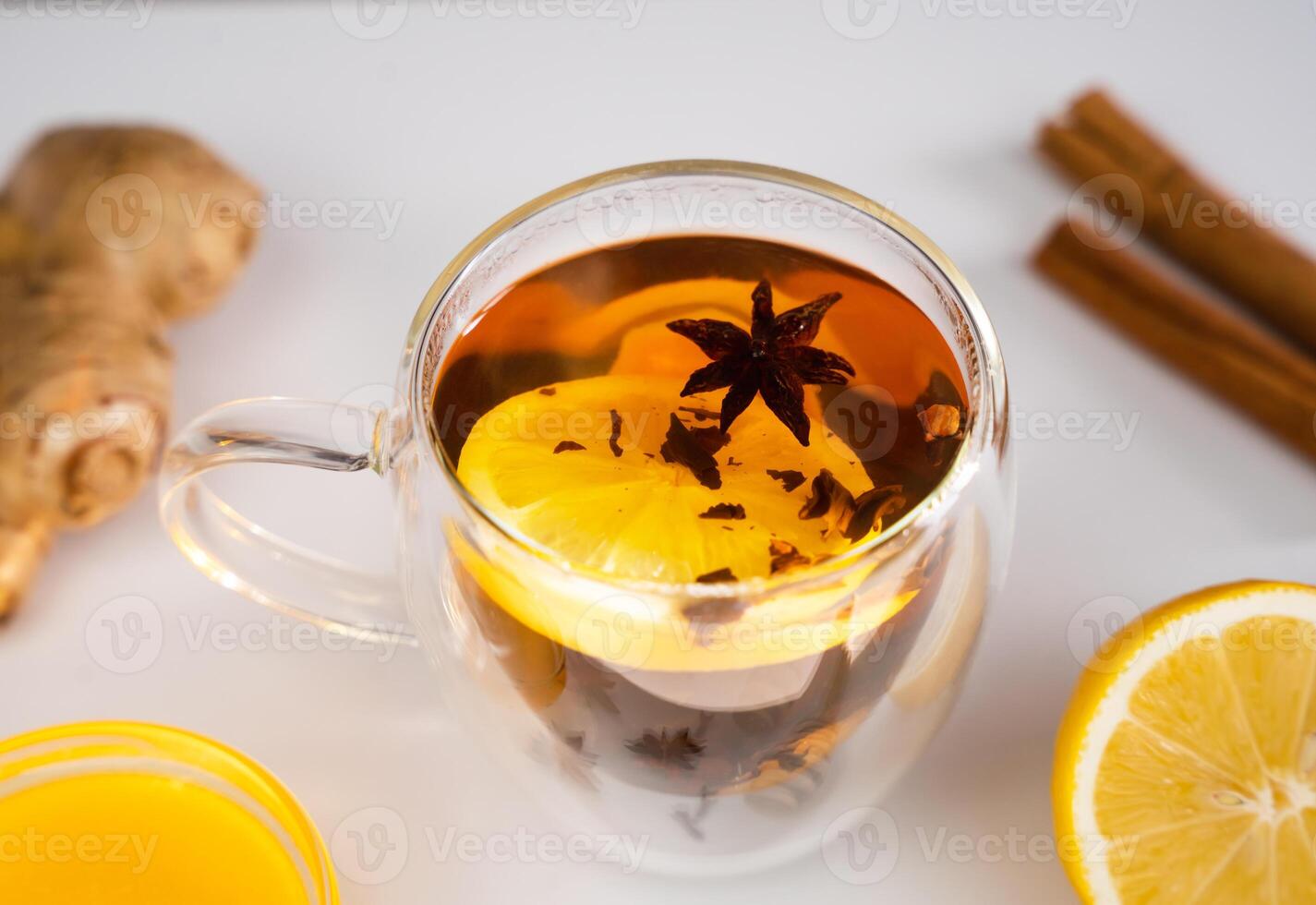 A tea with lemon, ginger and spices for breakfast on the table. Vitamin tea in the morning. Close-up. Selective focus. photo