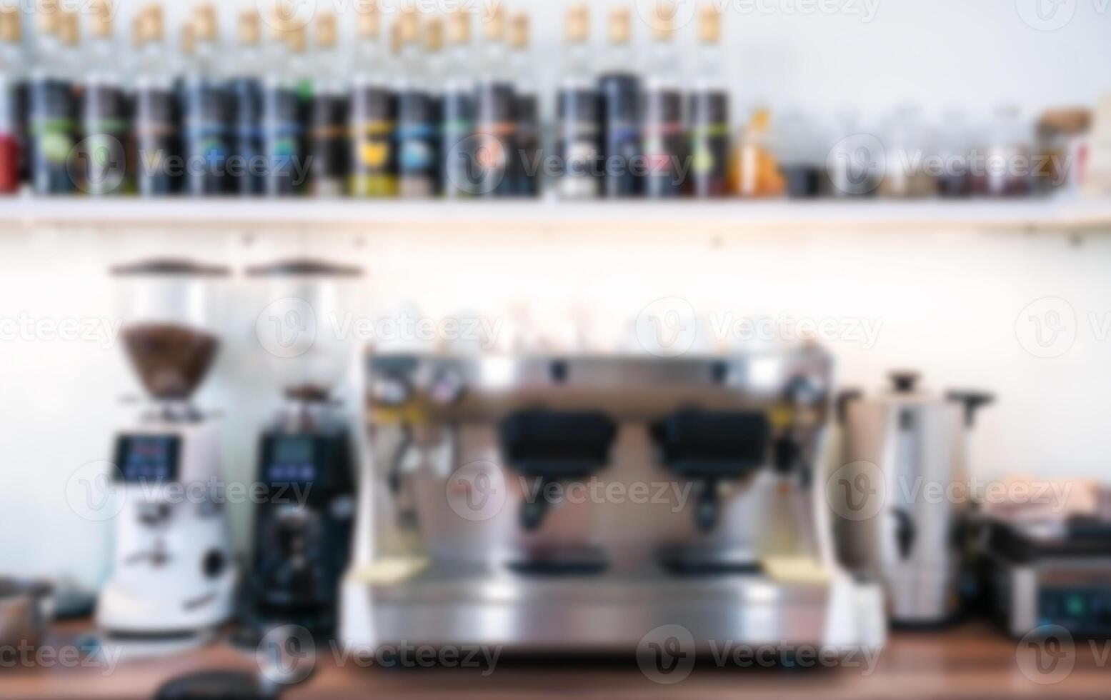 Blurred coffee shop interior with coffee machine, coffee grinders and mugs. photo