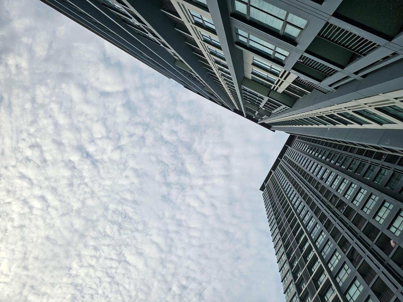 Low angle view of sky and cloud with modern office building or apartment photo