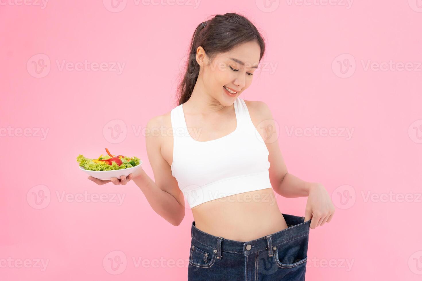 Women showing results of diet. Beautiful shape. female have a reduced waist size after under going a weight loss corse. can not wear jeans due to weight loss. balance, control, routines, exercise. photo