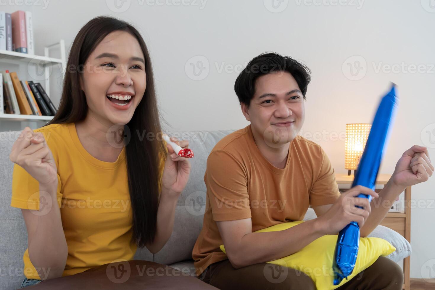 cheerful couple cheer sport, watching sporting, cheering for victory of their team. Happy energetic smiling. tv show, holiday, relax, recreation, soccer, football, series, cinema, cheer, win, fan club photo