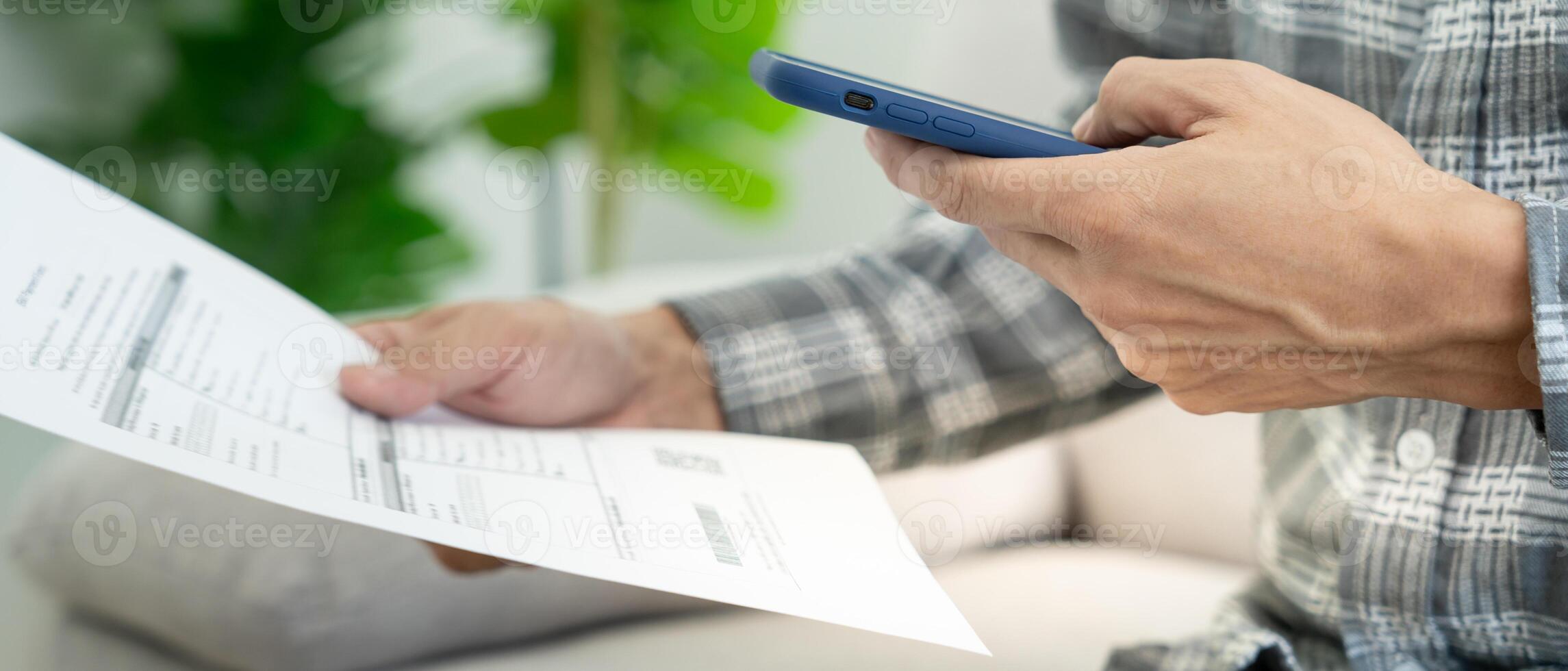 business man use phone to scan barcode or QR codes to pay credit card bill after receiving document invoice online. payment, receive, paying electricity, digital payments without money, technology photo