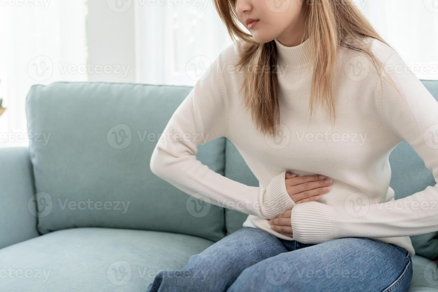 stomach ache. Asian women have abdominal pain, indigestion, gastritis, menstrual cramps, flatulence, diarrhea, distention, colon cancer, belly inflammation problem, suffer food poisoning, abdomen photo