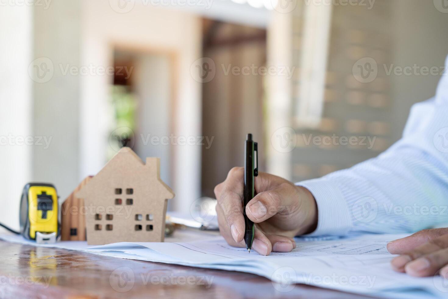 Engineers man recheck and review the blueprint of construction. Contractor inspection drawing before start project civil. Prepare construction project planning, consulting, architecture. photo